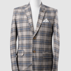 A men's tailored smart fit coat in a beige and blue plaid pattern on a mannequin. The coat features a lapel pin, light brown buttons, and a crisp white pocket square. Turkish stitching and branded fabric are present.
