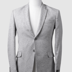 A tailored smart fit coat in a textured light grey fabric on a mannequin. The coat features a subtle lapel pin, matching grey buttons, and a clean breast pocket. Turkish stitching and branded fabric are present.