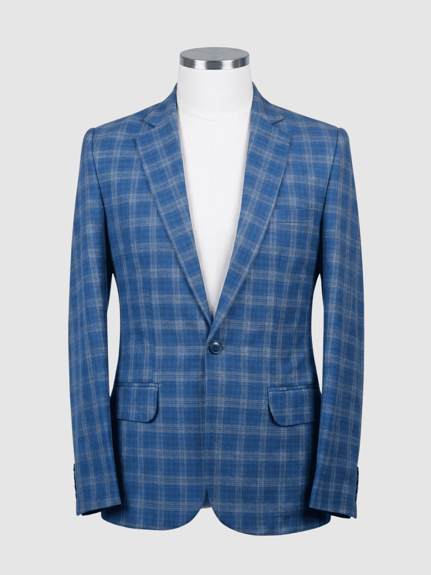 Iranian Fabric Blue Plaid Smart Fit Coat - Kamal Clan A tailored smart fit coat made of blue plaid Iranian fabric on a mannequin. The coat features a clean, simple design with matching blue buttons and no pocket square.