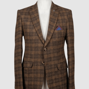A tailored smart fit coat made of Iranian brown plaid fabric on a mannequin. The coat features a lapel pin, tortoiseshell buttons, and a two-tone blue and burgundy pocket square.