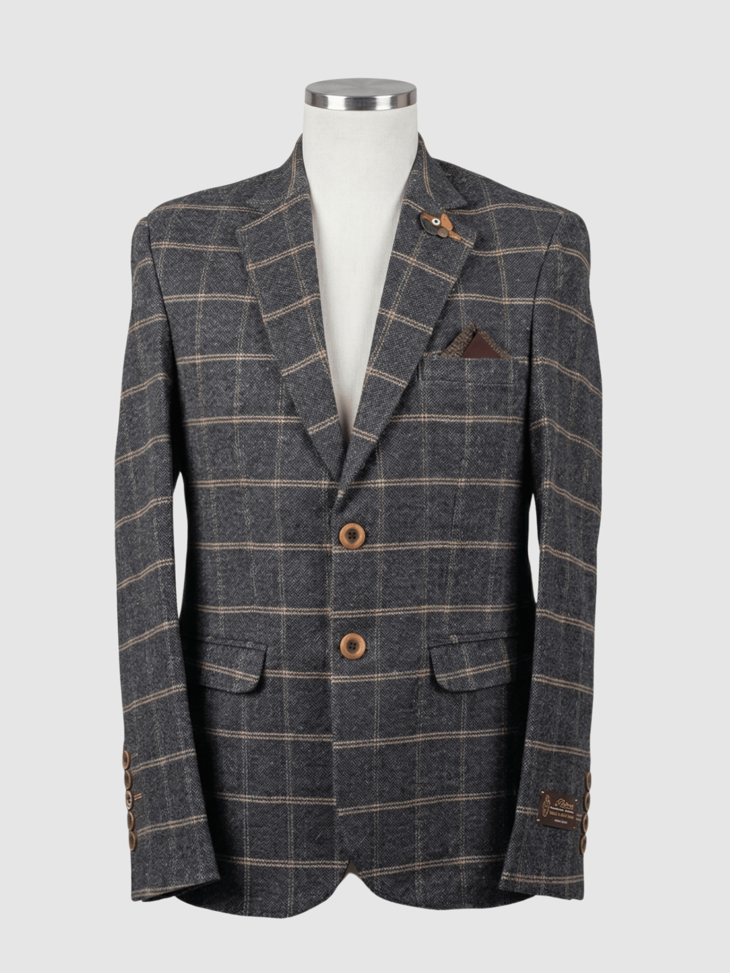 Iranian Fabric Burgundy Plaid Smart Fit Coat - Kamal Clan A tailored smart fit coat made of Iranian burgundy and charcoal grey plaid fabric on a mannequin. The coat features a subtle lapel pin, textured dark buttons, and a matching dark pocket square.