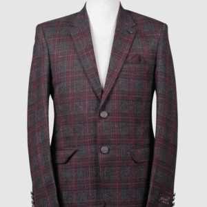A tailored smart fit coat made of Iranian burgundy and charcoal grey plaid fabric on a mannequin. The coat features a subtle lapel pin, textured dark buttons, and a matching dark pocket square.