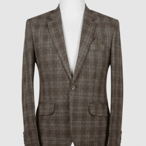 A tailored smart fit coat made of earthy brown and grey check Iranian fabric on a mannequin. The coat features a lapel pin, matching brown buttons, and a pointed solid brown pocket square.
