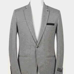 A tailored smart fit coat made of light grey Iranian fabric on a mannequin. The coat features a sleek lapel pin, dark buttons, and a striking black contrast trim on the breast pocket.